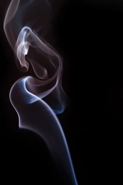 Swirling smoke from the incense on a homogeneous background — Stock Photo, Image