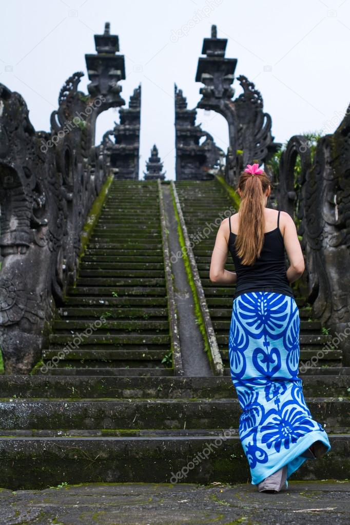 Girl climbing the stairs to the temple