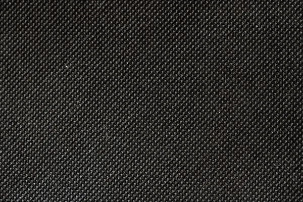 High resolution texture of black cloth with holes in staggered r — Stock Photo, Image