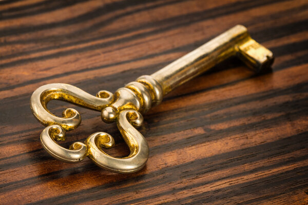 Antique key on a wooden background in high resolution