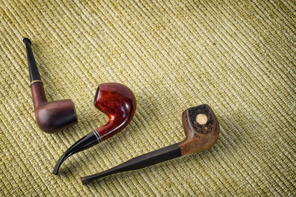 Three vintage smoking pipe on the burlap — Stock Photo, Image