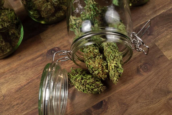 A glass jar with hemp buds — Fotografia de Stock