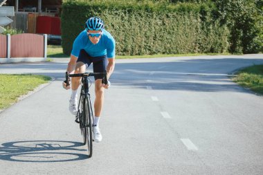 Road cycling racer taking a body position for the sprint on a bike