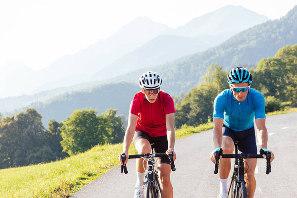 Two professional cyclist racers, male and female