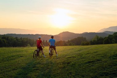Man and woman couple road cycling on race bike