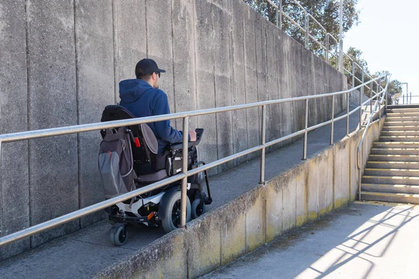 車椅子の男はアクセス可能なランプを使う — ストック写真