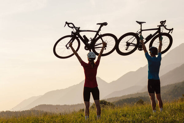 Man and woman couple road cycling on race bike outdoor in nature