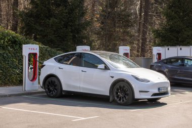Slovenia, Ljubljana - March 26 2022: Electric car Tesla charging at supercharger station