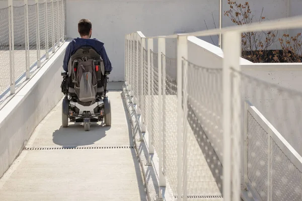 Man Wheelchair Approaching Building Moving Accessible Ramp Persons Disability — Zdjęcie stockowe