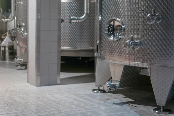 Modern wine cellar with new large inox stainless steel tanks for the fermentation.