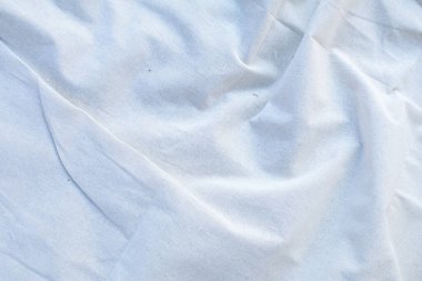 Blanket or Curtain of cotton pattern background with copy space for text decoration. Creased or wrinkled white fabric.