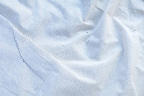 Blanket or Curtain of cotton pattern background with copy space for text decoration. Creased or wrinkled white fabric.