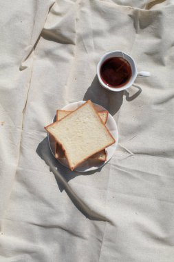 Coffee and bread on picnic blanket background relaxing on holiday. Still life concept. Copy space. Colorful autumn picnic