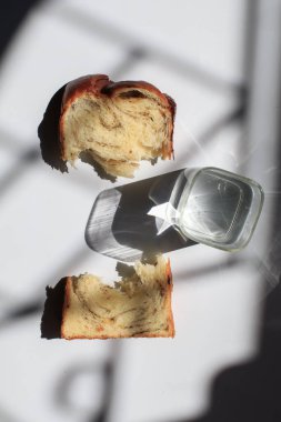 Pencerenin altından beyaz arka planda siyah trüf ve peynirli Brioche ekmeği. Lezzetli ekmekle birlikte fırın içeriği. Hamur işleri.