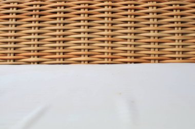 Close up wicker chair and white pad surface texture background. Utilization of rattan, especially as a raw material for furniture. traditional furniture.