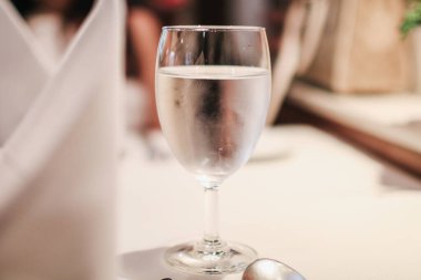 Wine glass of water on table setting for dining. Restaurant at the holiday. Love, dating and people concept