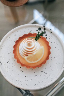 Lemon meringue tart pastry with citrus fruits. Delicious, appetizing, homemade dessert with lemon curd cream.