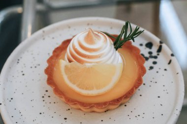 Lemon meringue tart pastry with citrus fruits. Delicious, appetizing, homemade dessert with lemon curd cream.