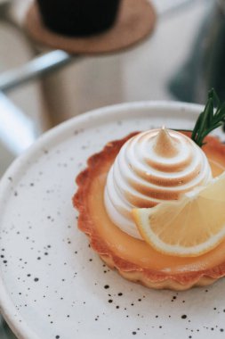 Lemon meringue tart pastry with citrus fruits. Delicious, appetizing, homemade dessert with lemon curd cream.
