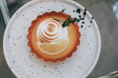 Lemon meringue tart pastry with citrus fruits. Delicious, appetizing, homemade dessert with lemon curd cream.