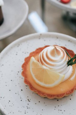 Lemon meringue tart pastry with citrus fruits. Delicious, appetizing, homemade dessert with lemon curd cream.