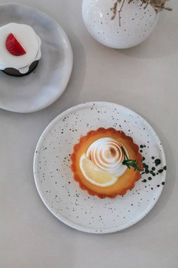 Lemon meringue tart pastry with citrus fruits. Delicious, appetizing, homemade dessert with lemon curd cream.