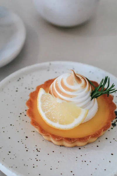 Lemon meringue tart pastry with citrus fruits. Delicious, appetizing, homemade dessert with lemon curd cream.
