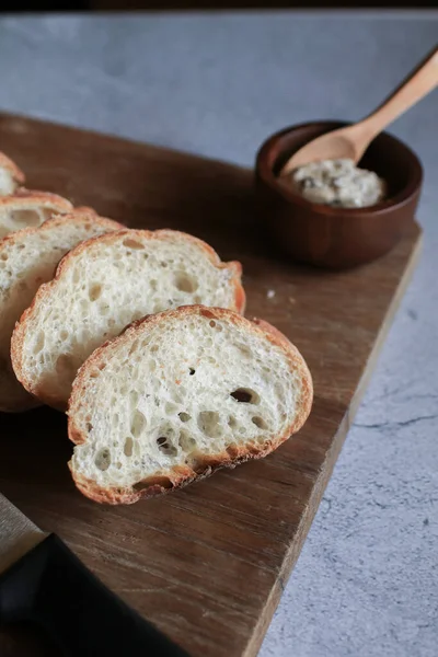 French Baguette bread on wooden cutting board background. Bread bun, Tasty delicious crusty bread in bakery