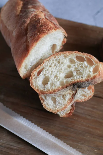 Baguette bread in package on gray background. Bread bun, French baguette. Tasty delicious crusty bread in bakery