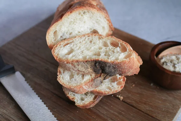 Baguette bread in package on gray background. Bread bun, French baguette. Tasty delicious crusty bread in bakery