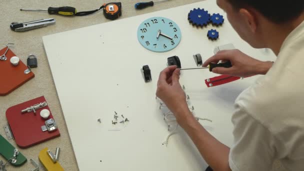 Young Man Assembles Busy Board Child Concept Diy Handyman Making — Stock Video