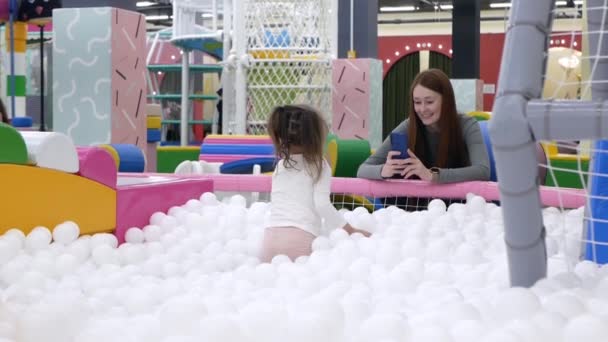 Kleinkindmädchen Wirft Ihrer Jungen Mutter Unterhaltungszentrum Weiße Bälle Kleines Mädchen — Stockvideo