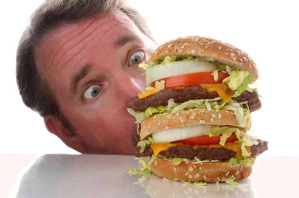 Double deck hamburger and man with eyes wide open — Stock Photo, Image