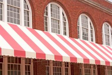 Brick Building With Striped Awning clipart