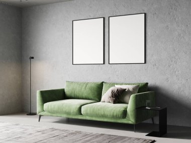 Boş iki çerçeve, açık beton oda içinde yeşil kanepe ve 3D çizim ile taklit edilir.