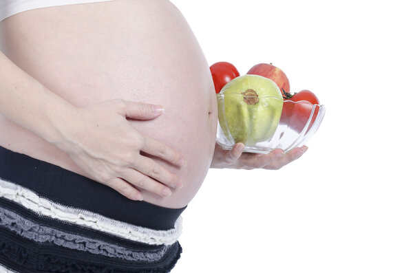 Pregnant woman with fresh fruit