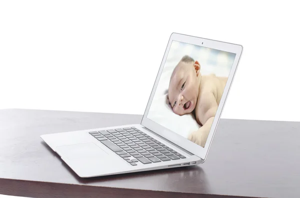 Smiling baby photo on a laptop — Stock Photo, Image