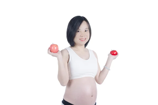 Mulher grávida segurando frutas — Fotografia de Stock