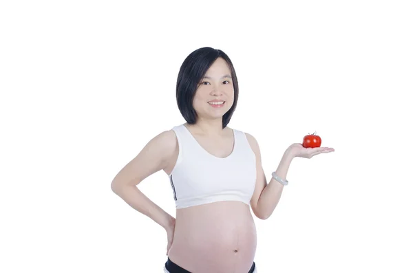 Piękna kobieta w ciąży z świeżych pomidorów na białym tle nad białym — Zdjęcie stockowe