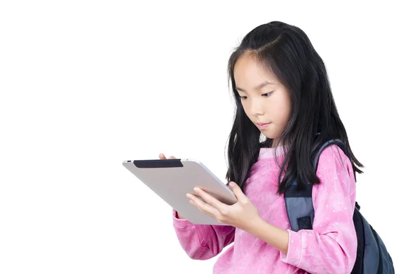十几岁的女孩在她手中的数码平板电脑，背包里 图库图片