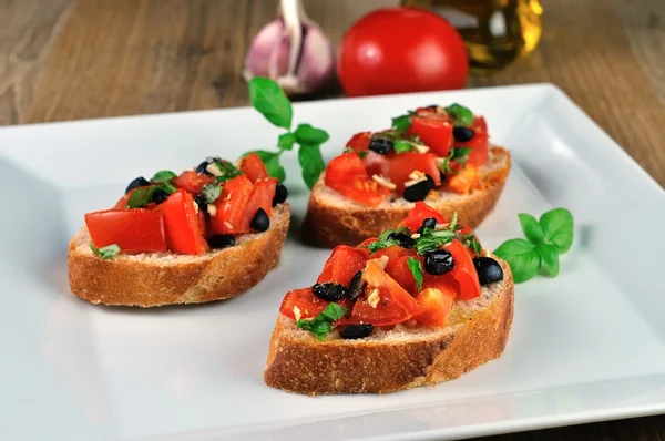 Bruschetta on wooden table — Stock Photo, Image