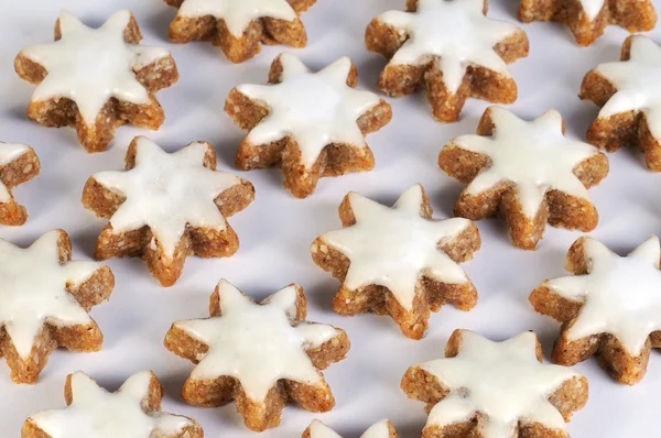 Tasty cinnamon stars against white background from the side — Stock Photo, Image