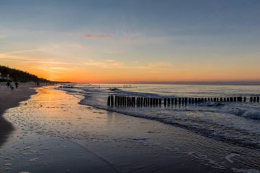 Mielno, Polonya 'daki sahil boyunca akşam yürüyüşü.