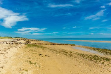 Beach walk on the beautiful Gold Beach off the coast of Ver-sur-Mer - Normandy - France