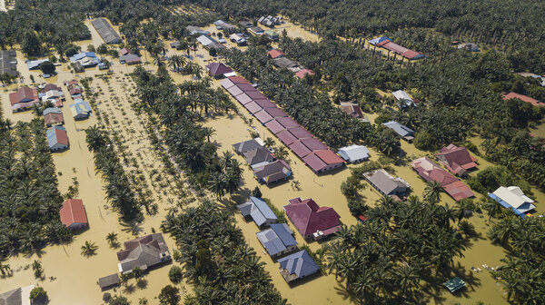 Bukit Changgang, Malaysia - Dec 21, 2021: Areal view of flooding that causes damage of the infrastructure and housing area. Selective focus, contains dust and grain