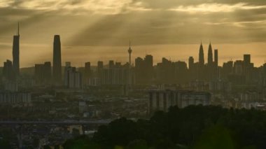 KUALA LUMPUR, MALAYSIA - July 9, 2022: Timelapse 4k UHD footage of cityscape of Kuala Lumpur and moving cloud and sunset