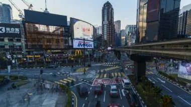 KUALA LUMPUR, MALAYSIA - JUNE 16, 2022: 4k UHD time-lapse footage of traffics, billboard and pedestrian at Kuala Lumpur, Malaysia