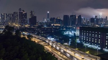 Kuala Lumpur, Malaysia - July 23, 2022 - Timelapse 4k UHD footage of cityscape of Kuala Lumpur at night and moving car time-lapse