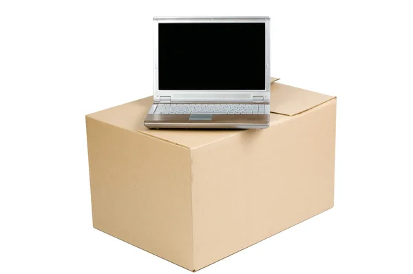 Cardboard box and a laptop — Stock Photo, Image