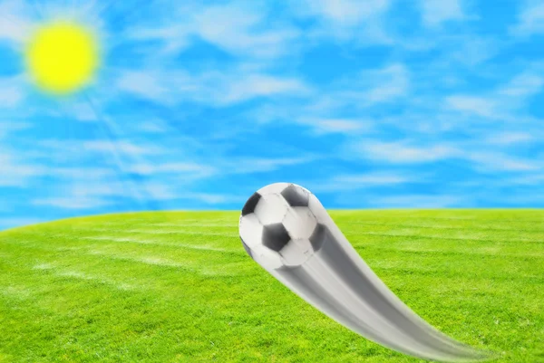 Soccer ball on sky and grass background — Stock Photo, Image